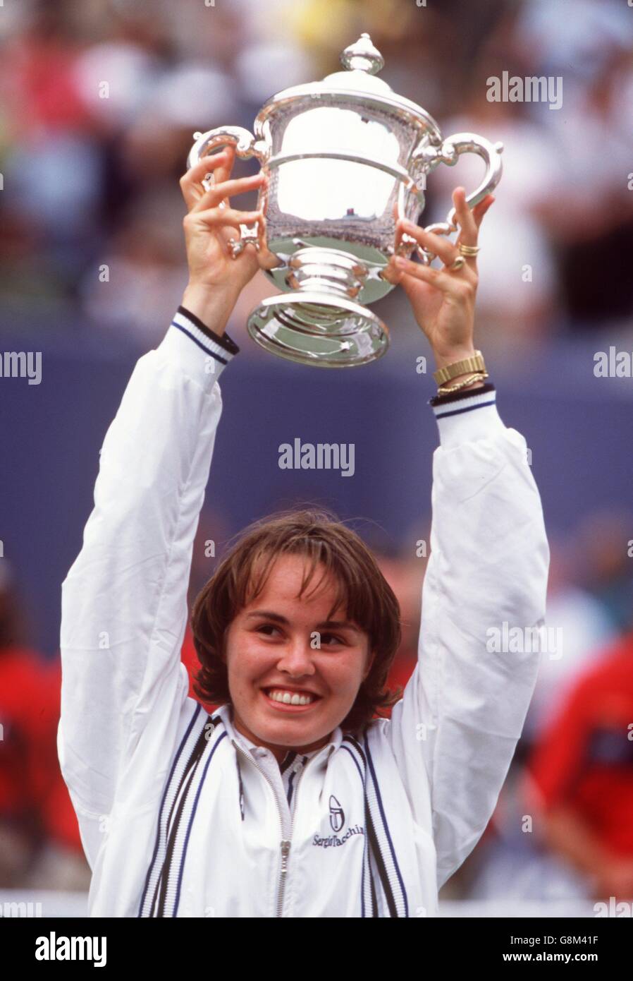 Us open champion martina hingis holds the trophy aloft hires stock