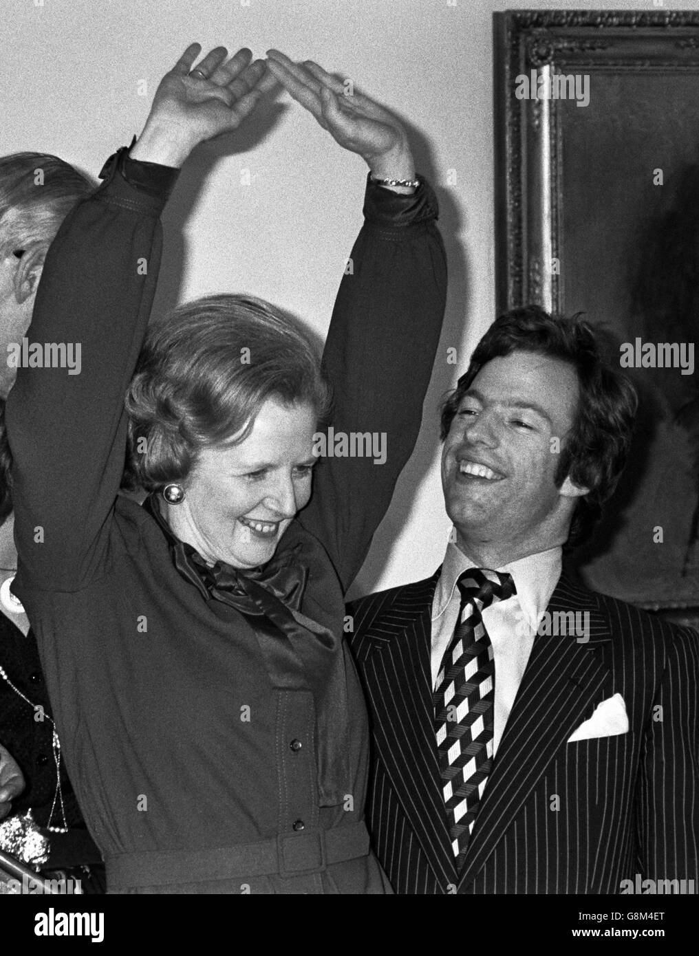 Mark Thatcher stands alongside his famous mother, Margaret, the Conservative leader, who told newsmen. 'I'm still not absolutely certain. We were cautiously optimistic, now we are optimistic. Stock Photo