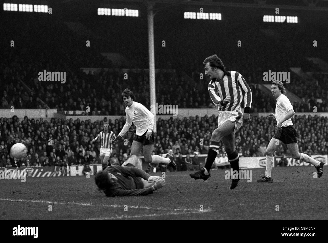 Spurs defenders Terry Naylor (right) Cyril Knowles race back too late as Alan Hudson hammers the ball past goalkeeper Barry Daines to score Stoke City's second goal in this afternoons League Division One match. Greenhoff scored the Midland club's other goal in their two-nil victory. 169835-2 Stock Photo