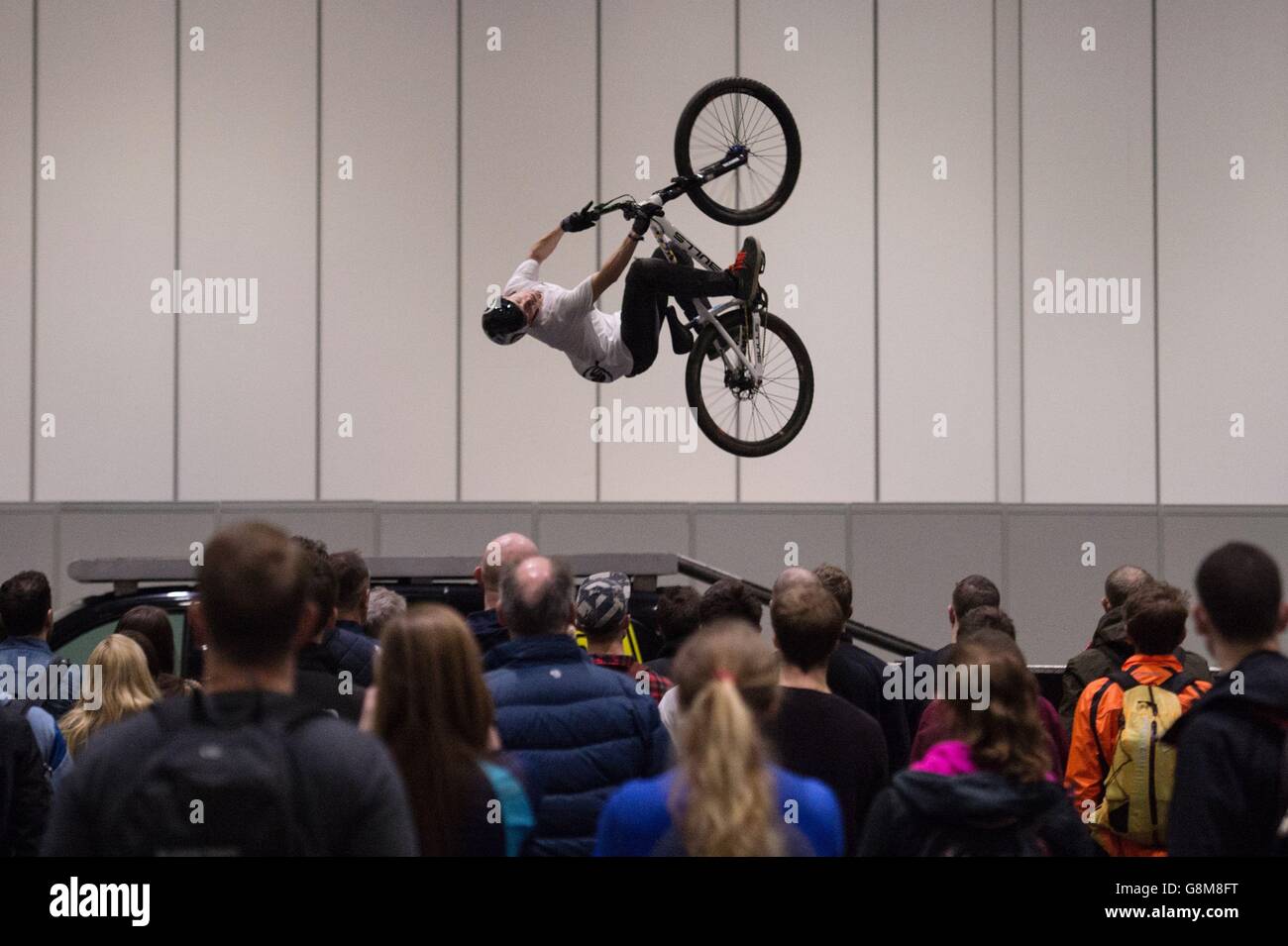 A BMX rider performs stunts at the London Bike Show at the Excel centre in east London. Stock Photo