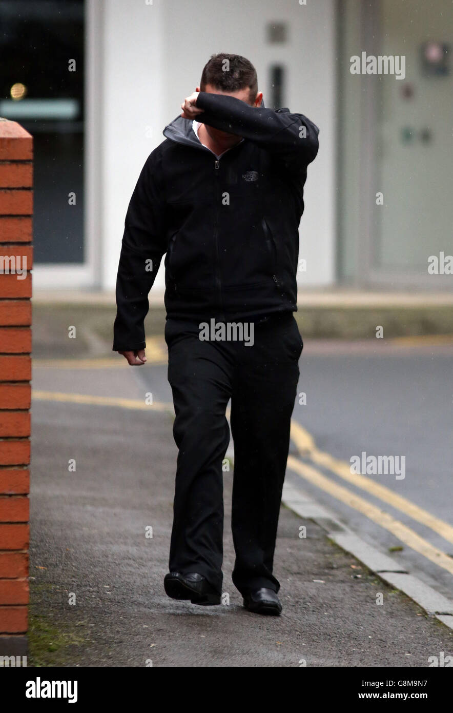 Dean Goble covers his face as he arrives at Swindon Crown Court, where he is accused of deliberately driving head-on at three cyclists to either force them off the road or 'scare the living daylights' out of them. Stock Photo