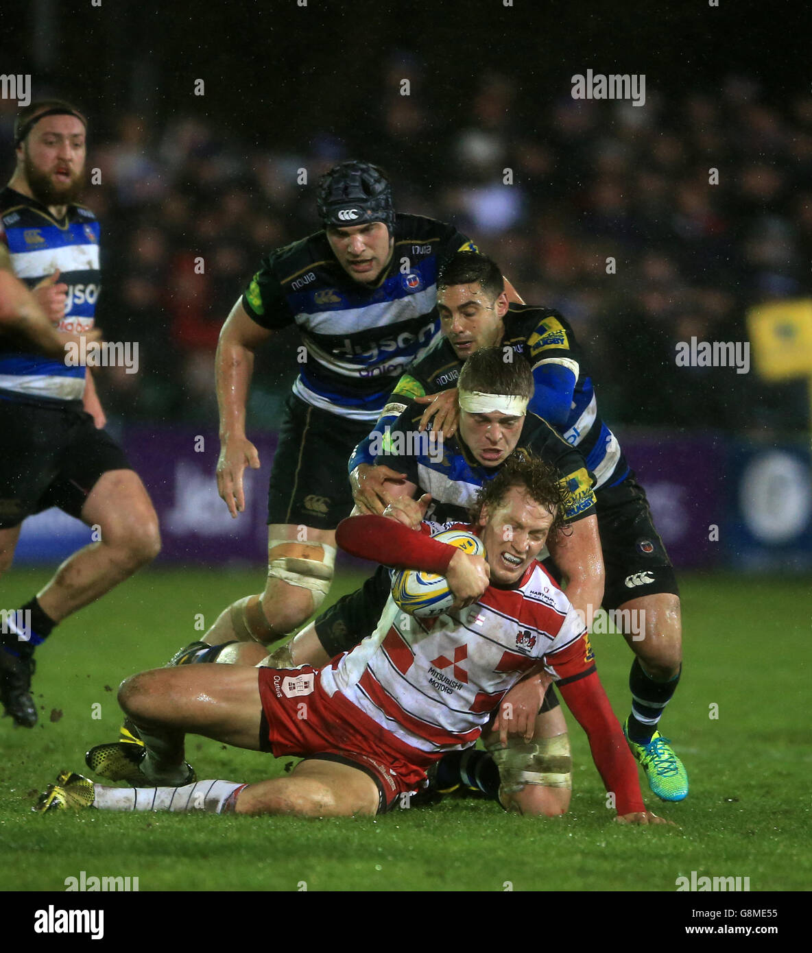 Gloucester's Billy Twelvetrees is held a trio of Bath players during the Aviva Premiership match at the Recreation Ground, Bath. Stock Photo