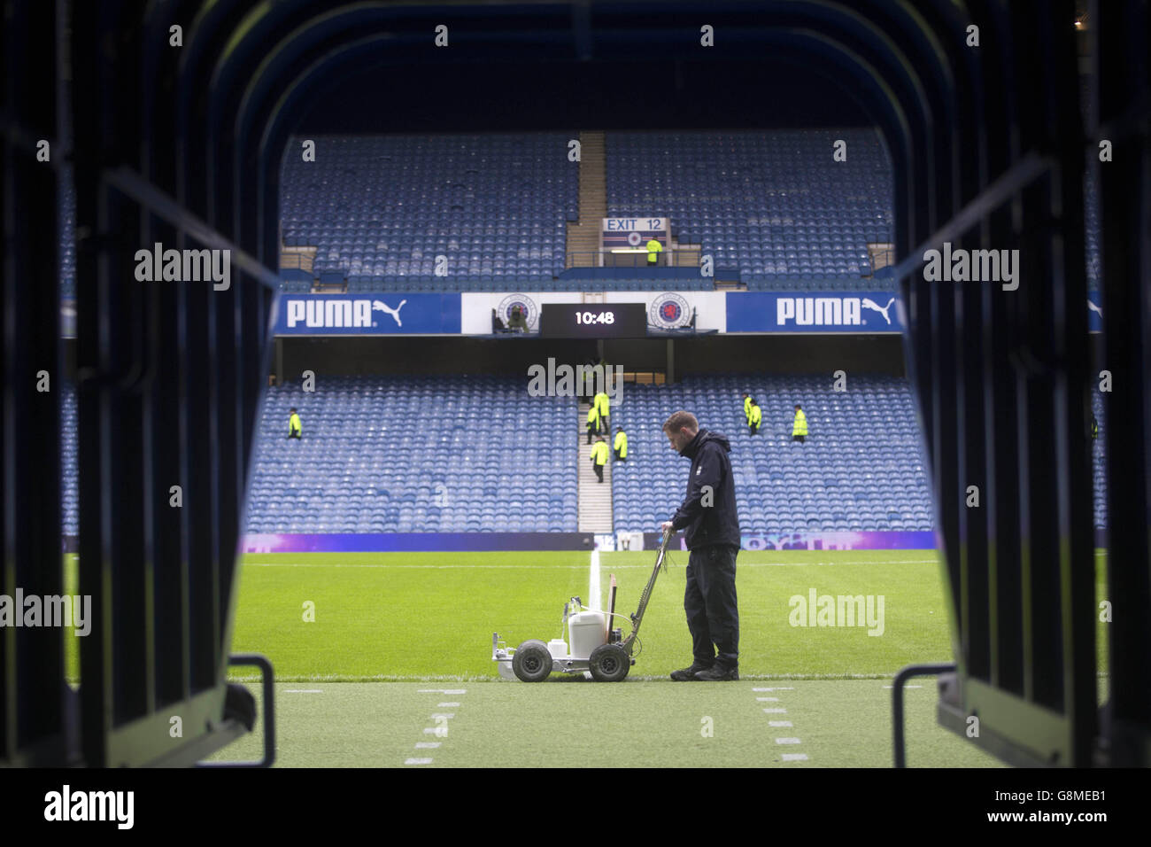 Groundstaff prepare the lines before the Ladbrokes Scottish Championship match at the Ibrox Stadium, Glasgow. Stock Photo
