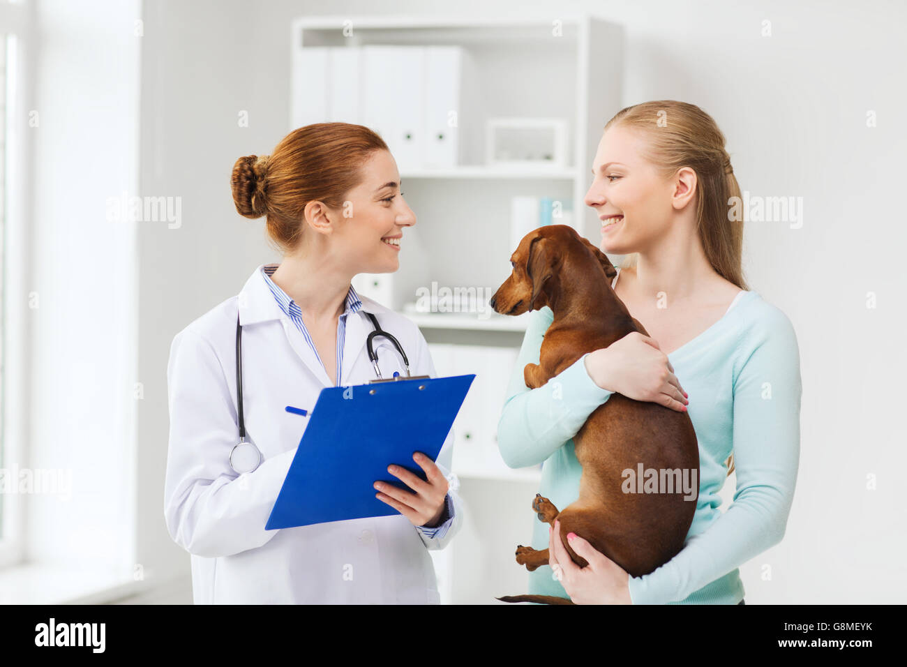 happy woman with dog and doctor at vet clinic Stock Photo - Alamy happy woman with dog and doctor at vet clinic Stock Photo - Alamy