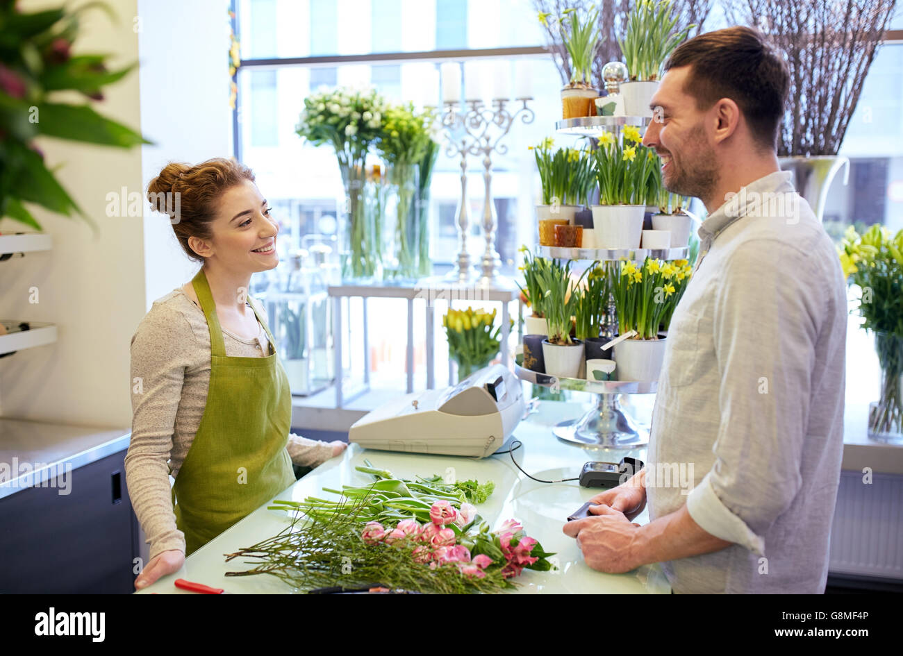 smiling florist woman and man at flower shop Stock Photo - Alamy