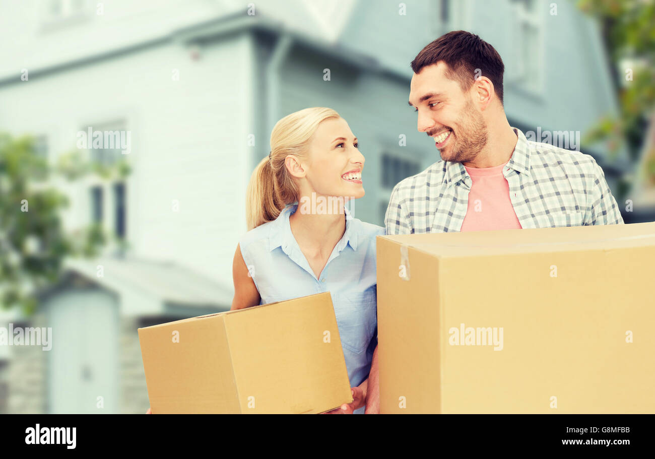 couple with cardboard boxes moving to new home Stock Photo - Alamy