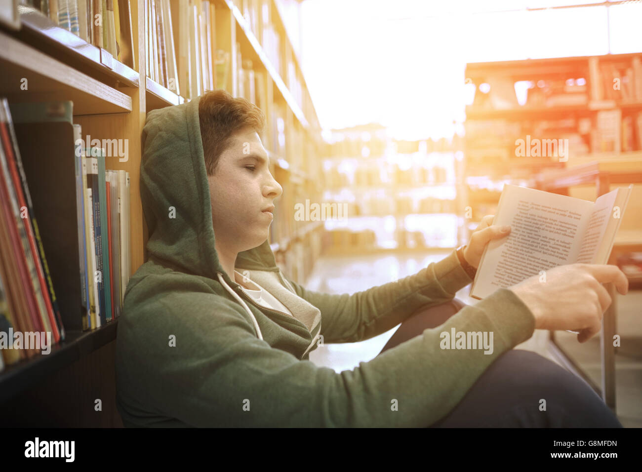 student boy or young man reading book in library Stock Photo