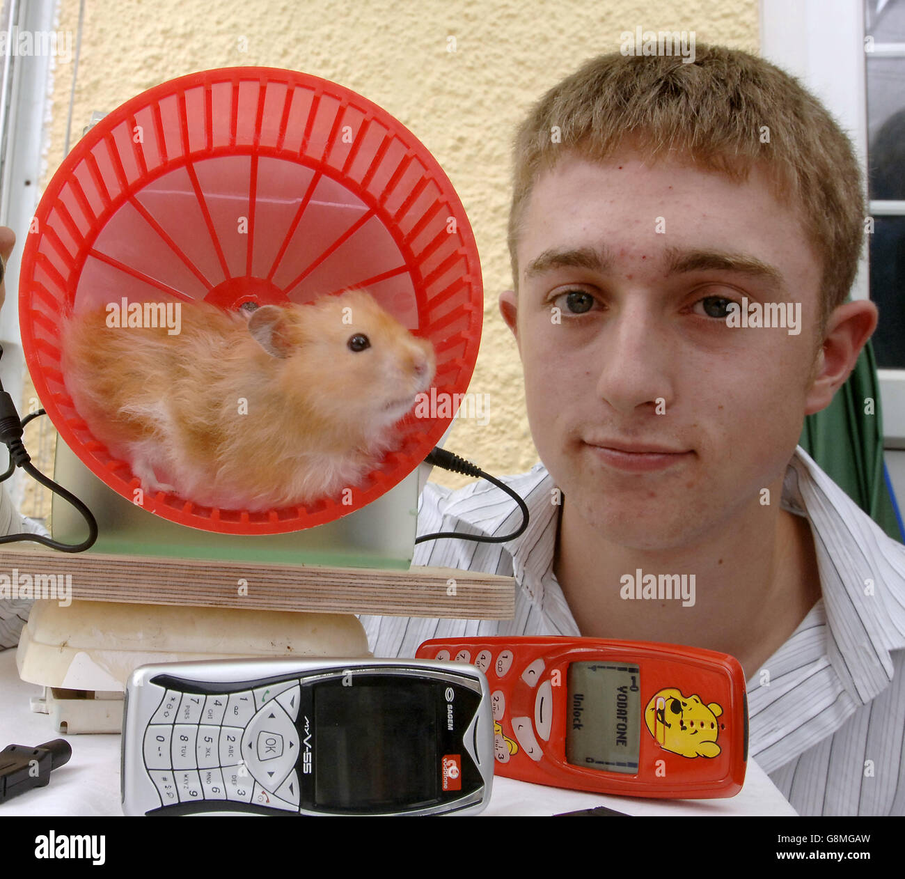 Peter Ash, 16 with his hamster powered mobile phone charger 'Elvis' at his home in Lawford, Somerset. Stock Photo