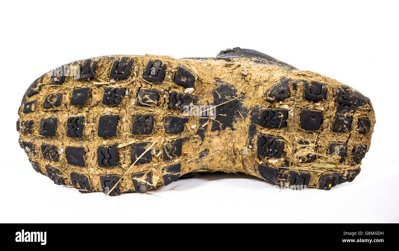 Sole of muddy shoes after a hike on the mountain. Stock Photo