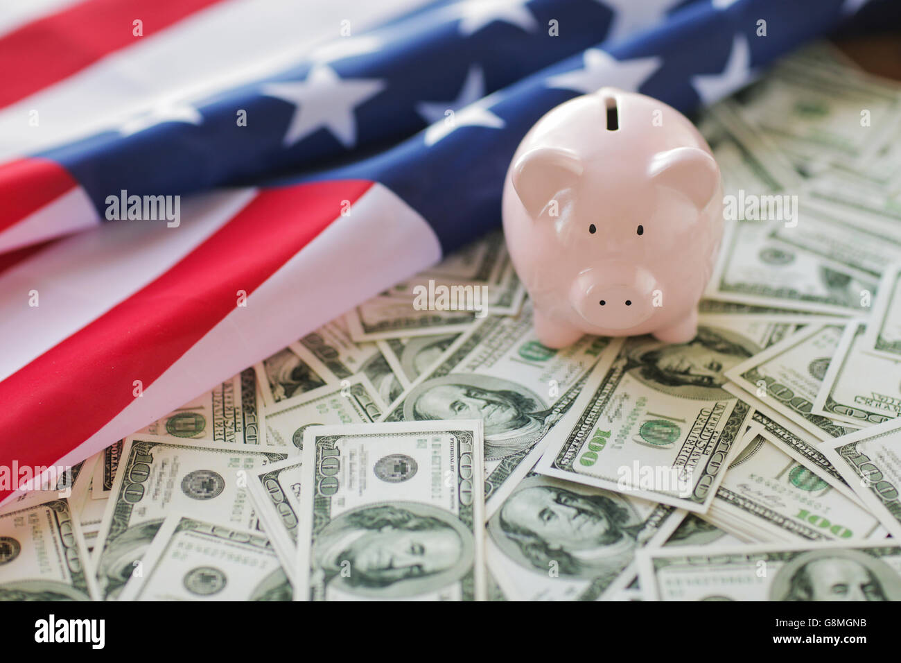 close up of american flag, piggy bank and money Stock Photo