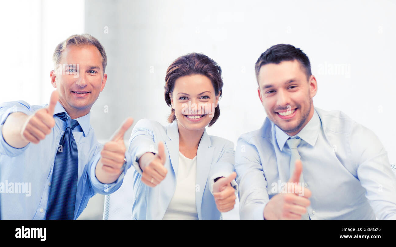business team showing thumbs up in office Stock Photo - Alamy