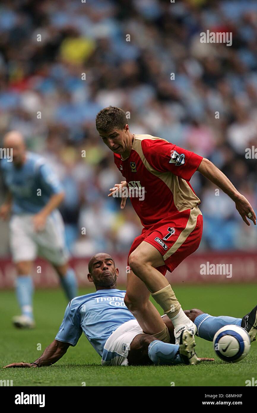 Manchester City's Trevor SInclair slides in to tackle Portsmouth's ...