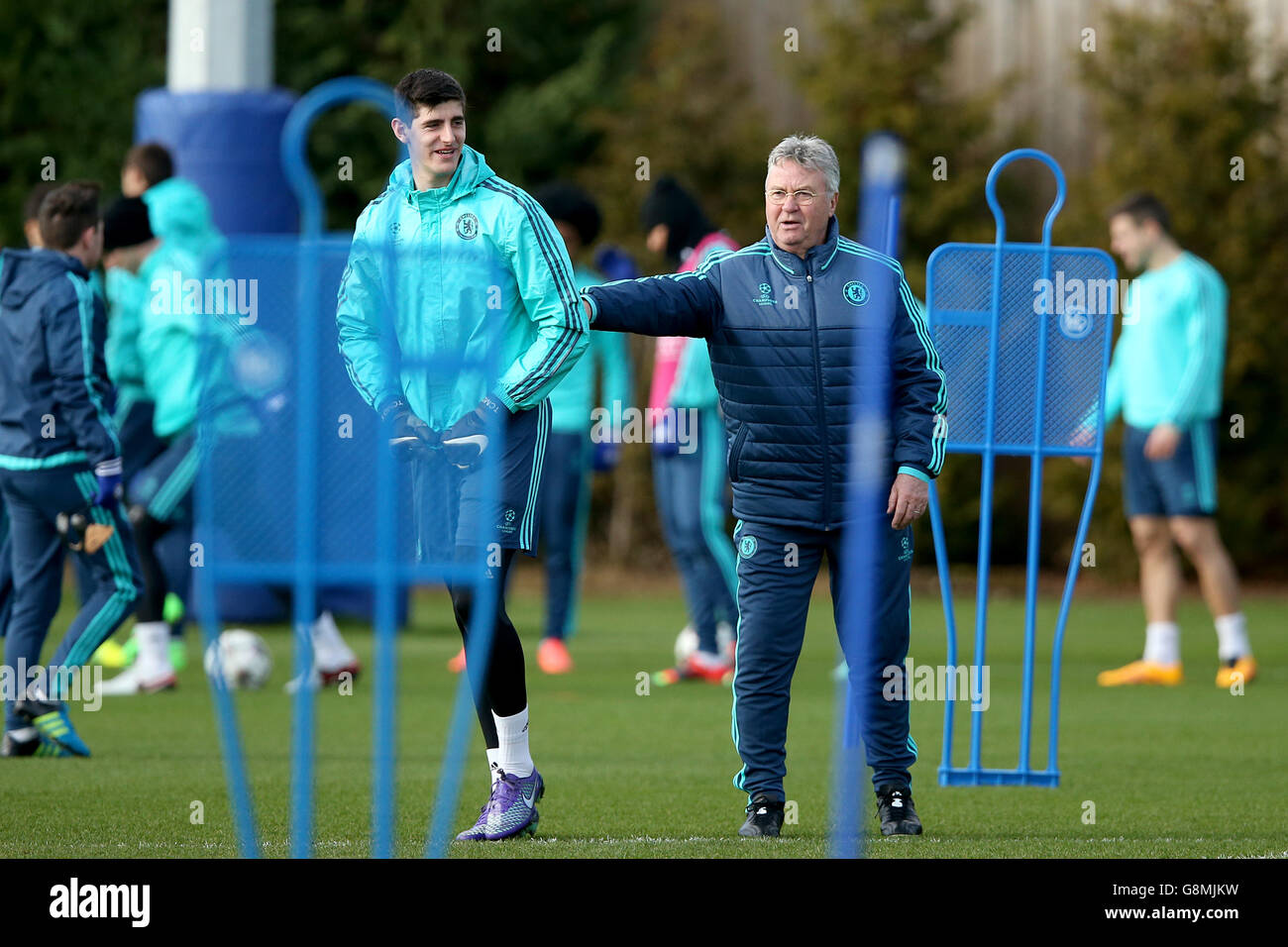 Chelsea interim manager Guus Hiddink (right) with goalkeeper Thibaut Courtois during the training session at Cobham Training Ground, London. Stock Photo