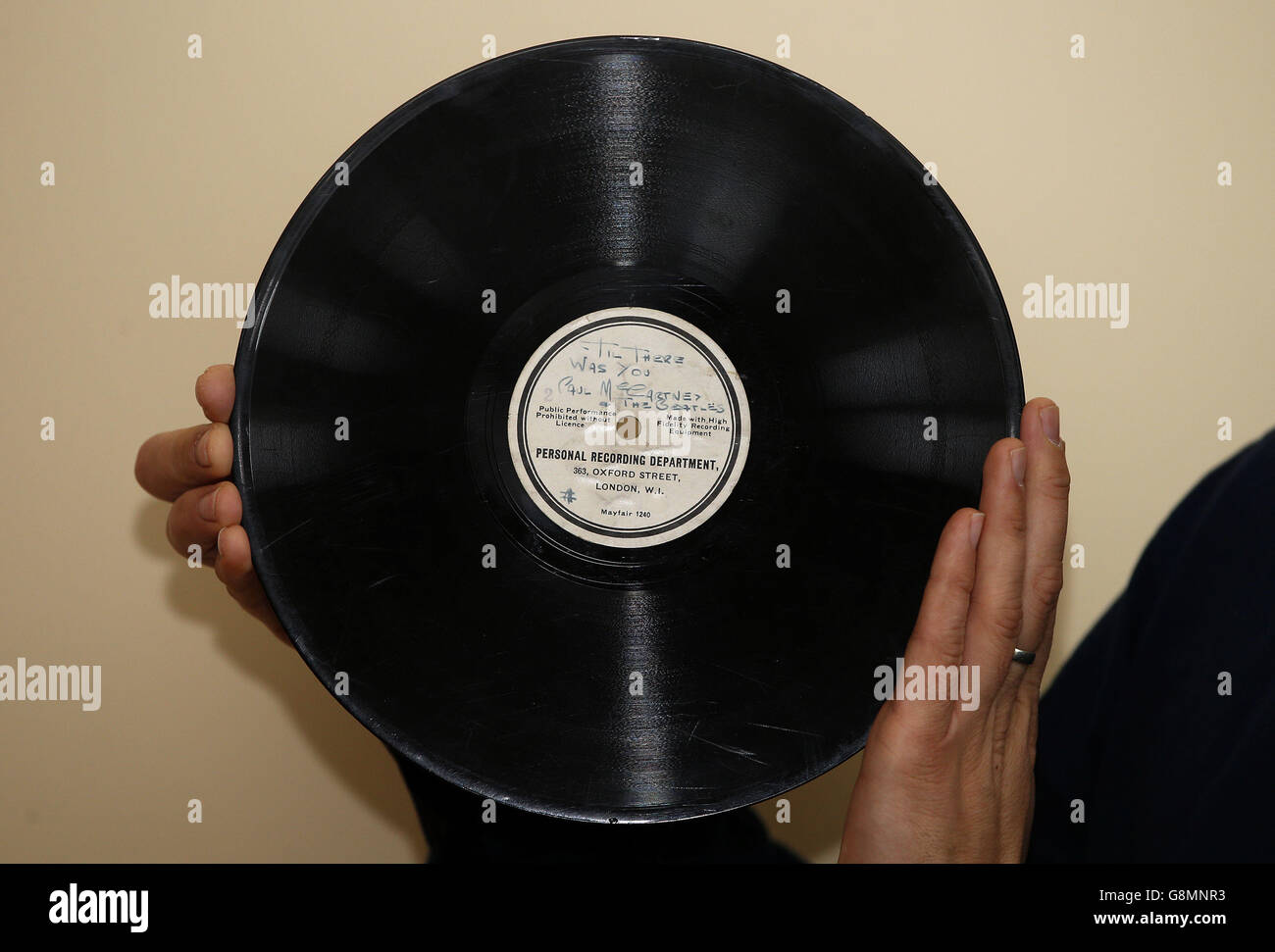 The record that launched The Beatles, One of the rarest and most collectable of all Beatles records is expected to sell for over £10,000 when it comes up for sale next month. The unique ten-inch 78RPM acetate featuring 'Hello Little Girl' on one side and 'Till There Was You' on the other was pressed at the HMV record store on Oxford St London before being presented by the group's manager Brian Epstein to George Martin (EMI) in his desperate attempt to get them a recording contract. Paul Fairweather from Omega Auctions with the record before it is sold.. Stock Photo