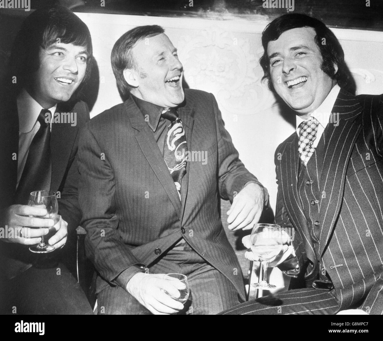 (l-r) Disc jockeys Tony Blackburn, Jimmy Young and Terry Wogan celebrate the BBC's second half-century at the Variety Club of Great Britain's lunch at the Dorchester Hotel in London. Stock Photo