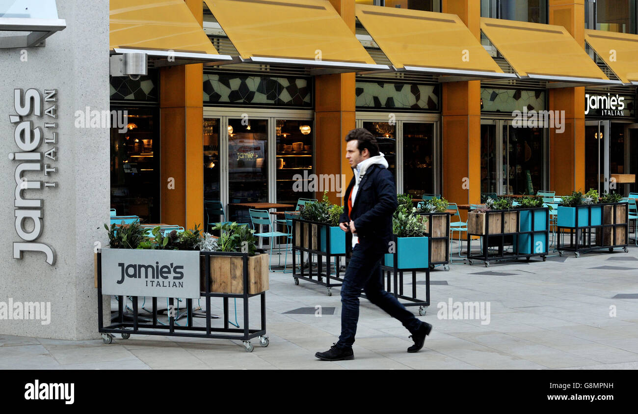 A man walks past Jamie's Italian, the restaurant chain founded and majority-owned by celebrity chef Jamie Oliver, on Old Bailey, central London. Stock Photo