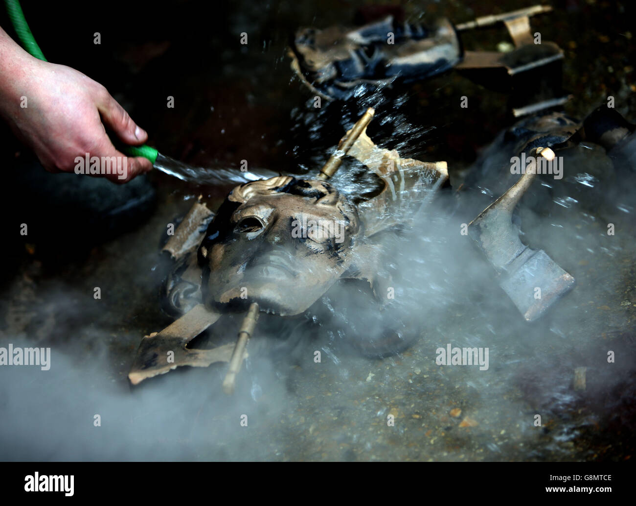 Bronze metal statues are cooled down as they are made into BAFTA masks