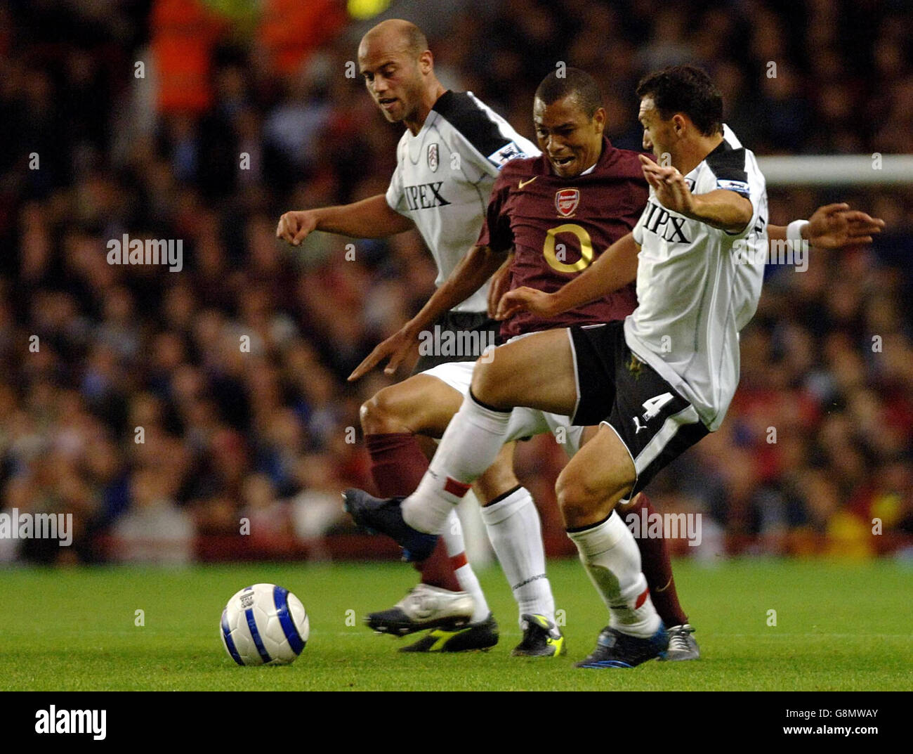 Arsenal's Ashley Cole battles for the ball with Fulham's Claus Jensen (L) and Steed Malbranque (R) during the Barclays Premiership match at Highbury, London, Wednesday August 24, 2005. PRESS ASSOCIATION Photo. Photo credit should read: Sean Dempsey/PA Stock Photo