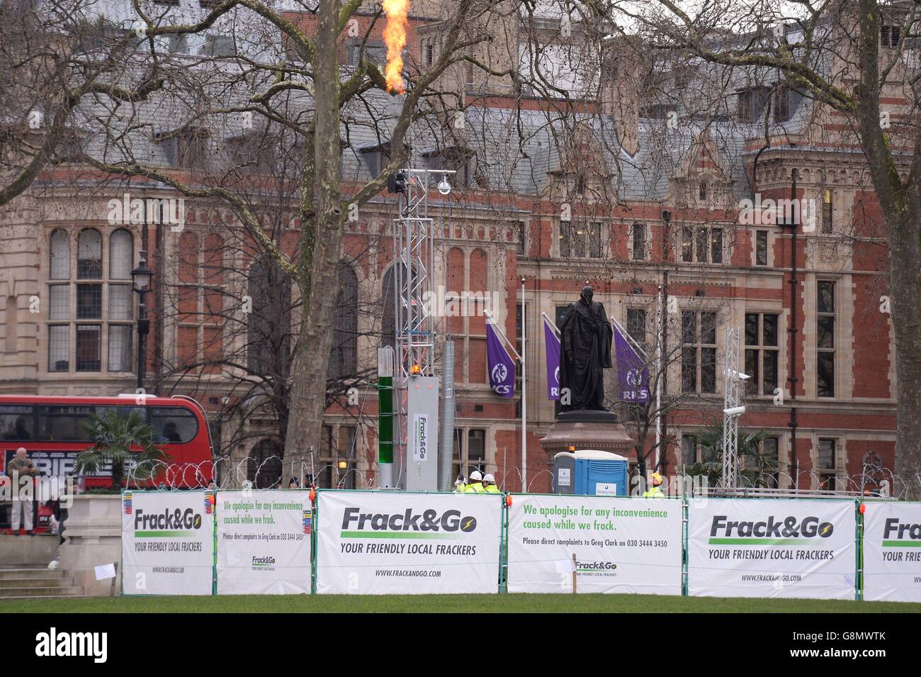 Flames spurt from an imitation fracking rig and drill installed by Greenpeace activists in Parliament Square, central London, in protest against the move by the Government to drive forward with the controversial process for extracting gas in the UK. Stock Photo