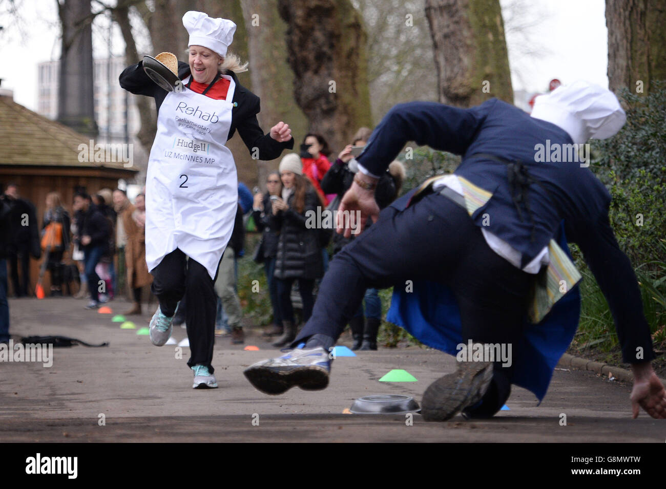 Heywood and Middleton MP Liz McInnes goes past Lord St John of Bletso as they take part the annual Rehab Parliamentary Pancake Race in which MPs, Lords and members of the media race each other on pancake day to raise money for the charity Rehab, in Victoria Tower Gardens, London. Stock Photo