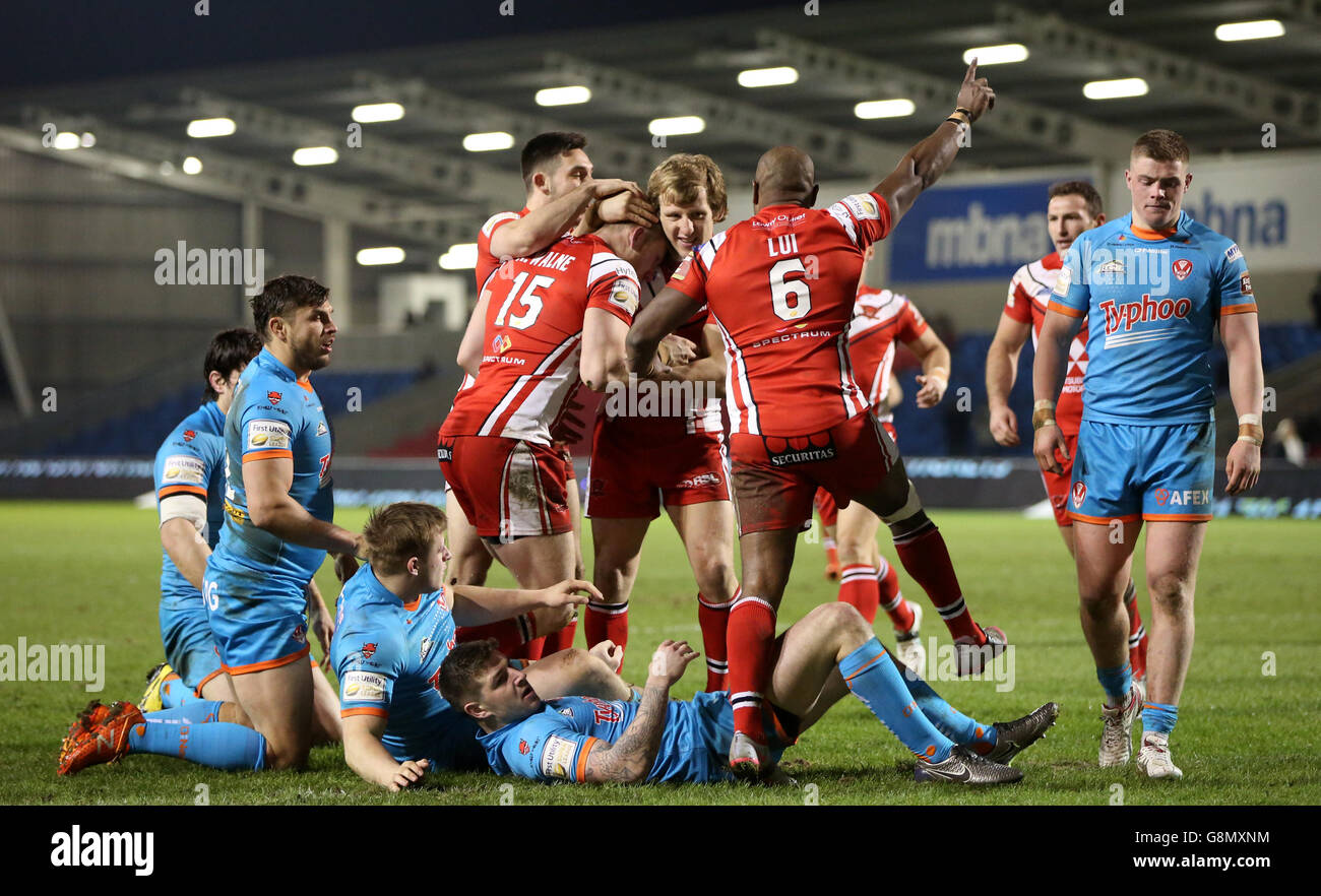 Salford Red Devils' Adam Walne (no.15) celebrates scoring a try with team-mates during the First Utility Super League match at the AJ Bell Stadium, Salford. Stock Photo