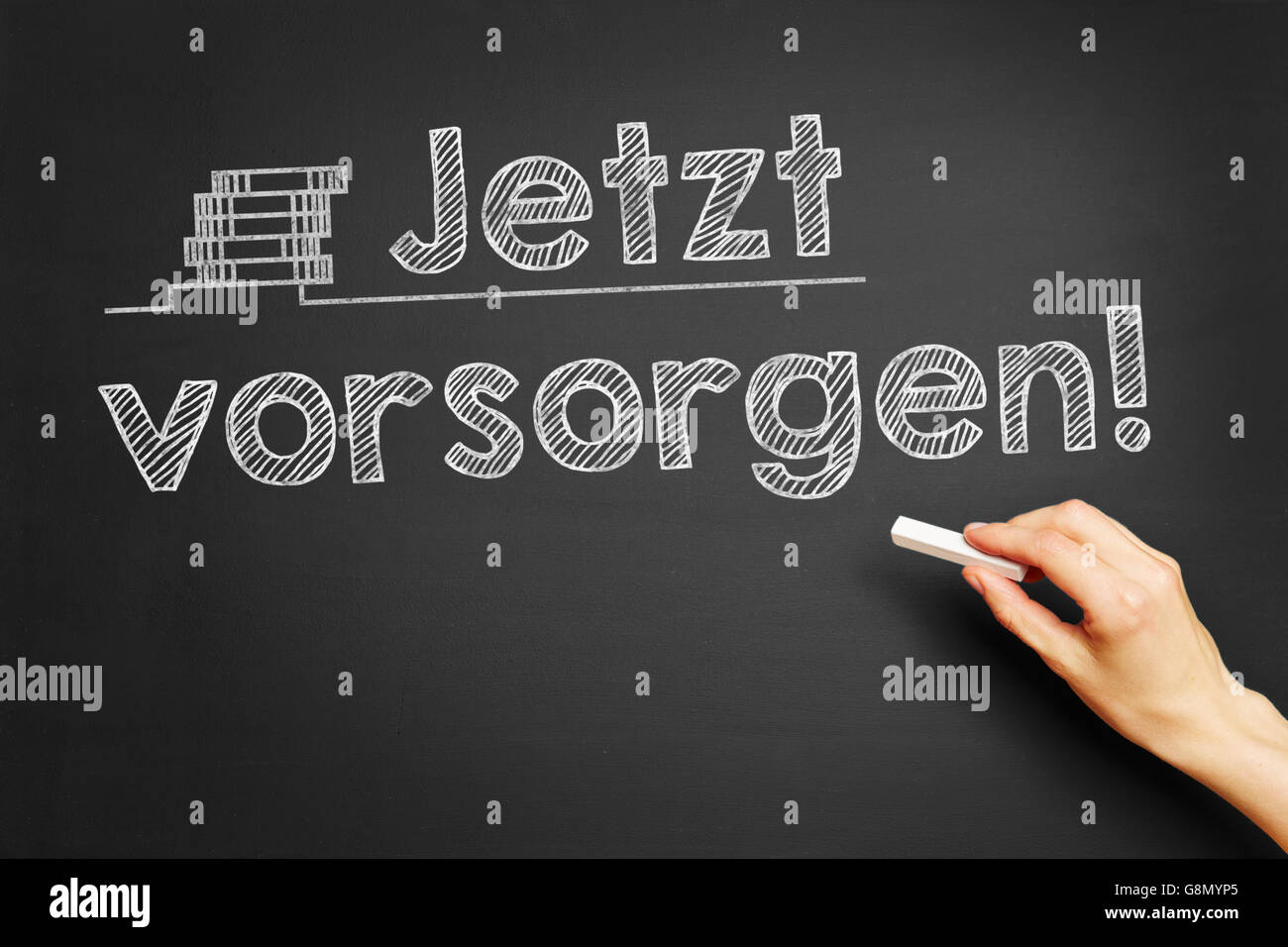 Hand writes in German "Jetzt vorsorgen!" (Take precaution now!) on blackboard Stock Photo