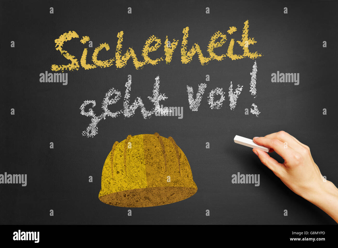 Hand writing the German slogan "Sicherheit geht vor!" (Safety first) on