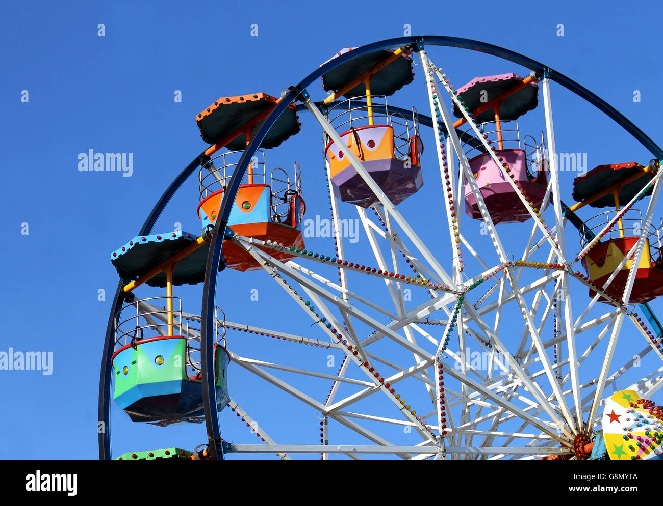 Colorful ferris wheel with blue sky background Stock Photo - Alamy