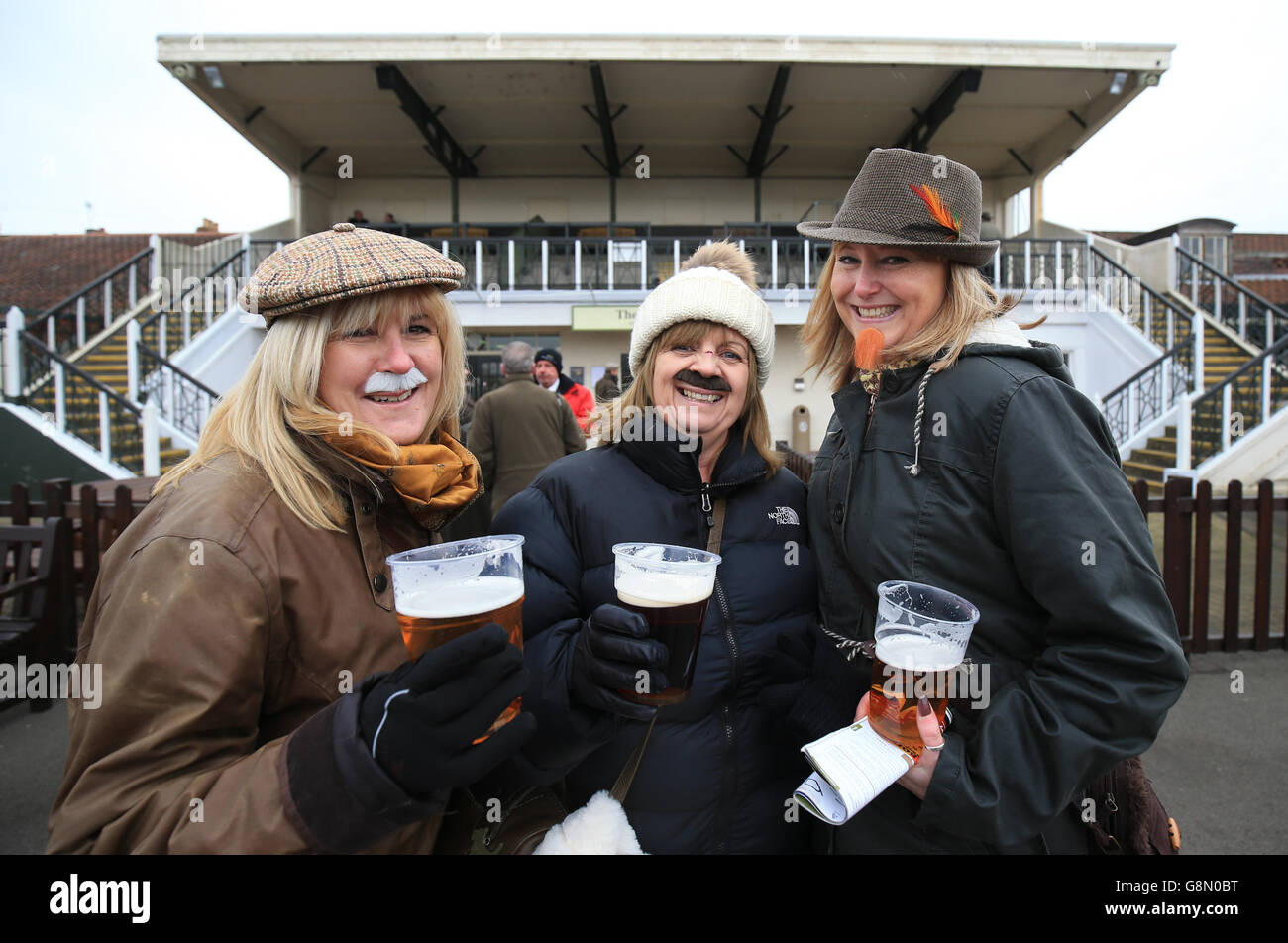 Gentlemen's and Kingmaker Chase Day - Warwick Racecourse. Three ladies hoping to win the 'best dressed male' competition during the Gentlemen's and Kingmaker Chase Day at Warwick racecourse. Stock Photo