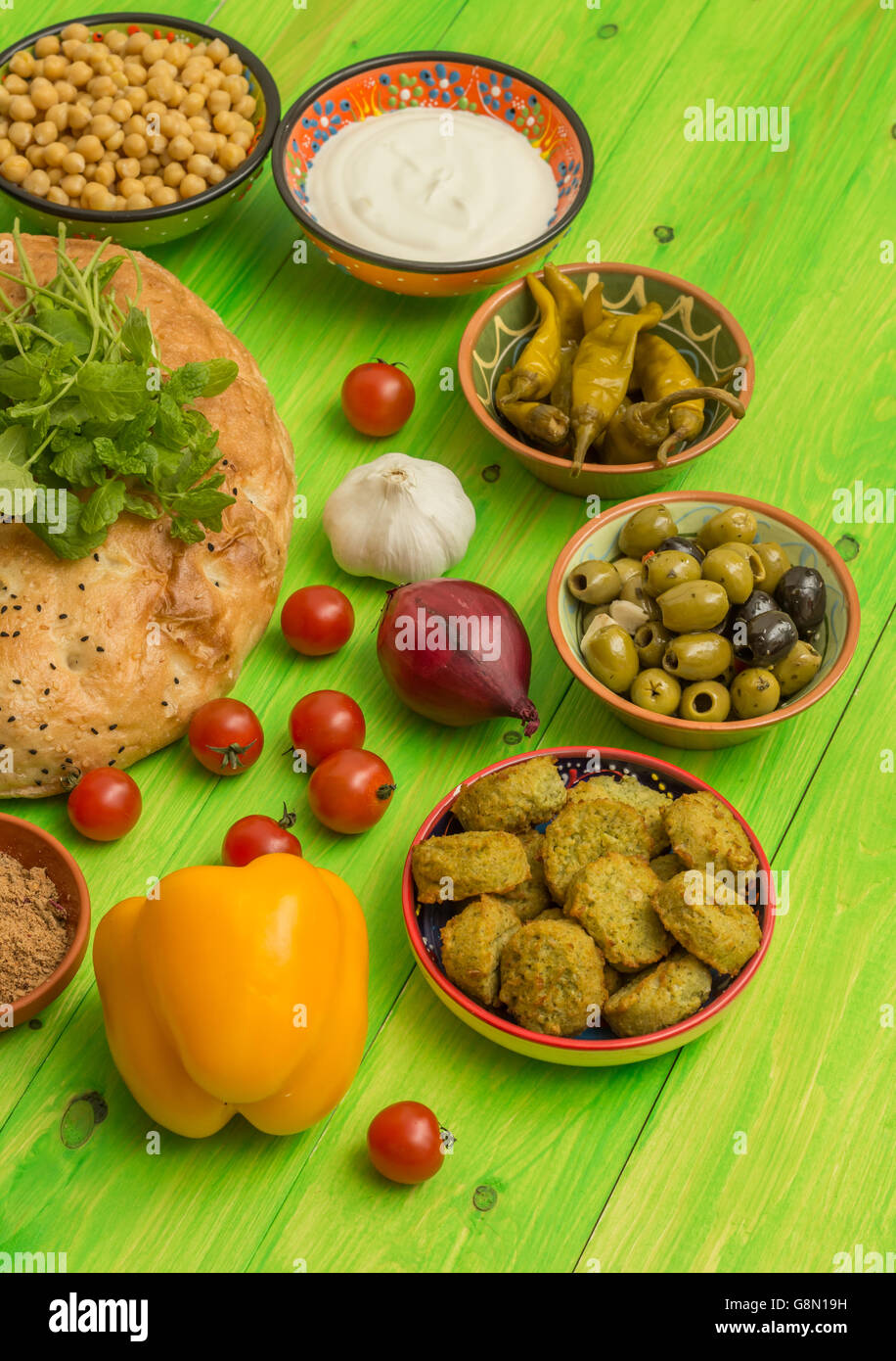 Ingredients to make a turkish sandwich with falafel, lettuce, pepper
