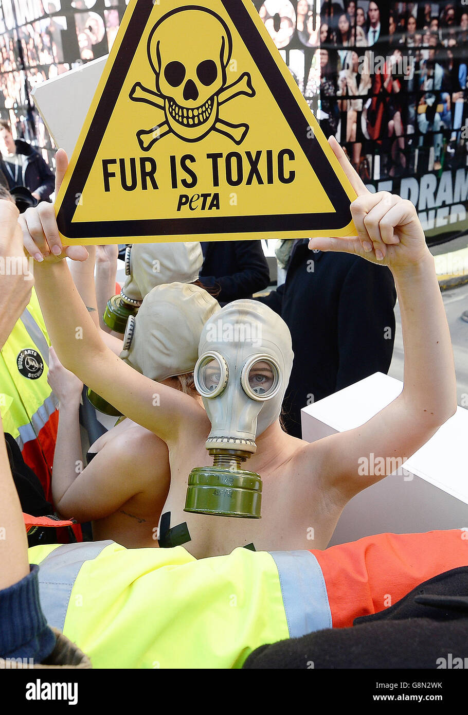 Models dressed in knickers and gas masks from Peta protest against the use of fur clothing and accessories, during London Fashion Week, in Soho, London. Stock Photo