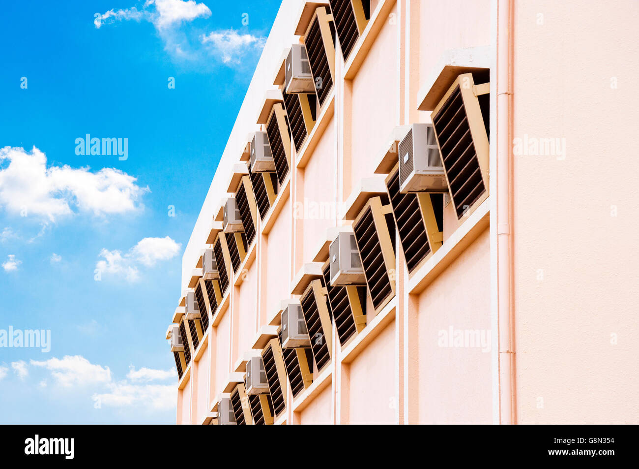 Many Air Conditioners Outside Building over Sky Stock Photo