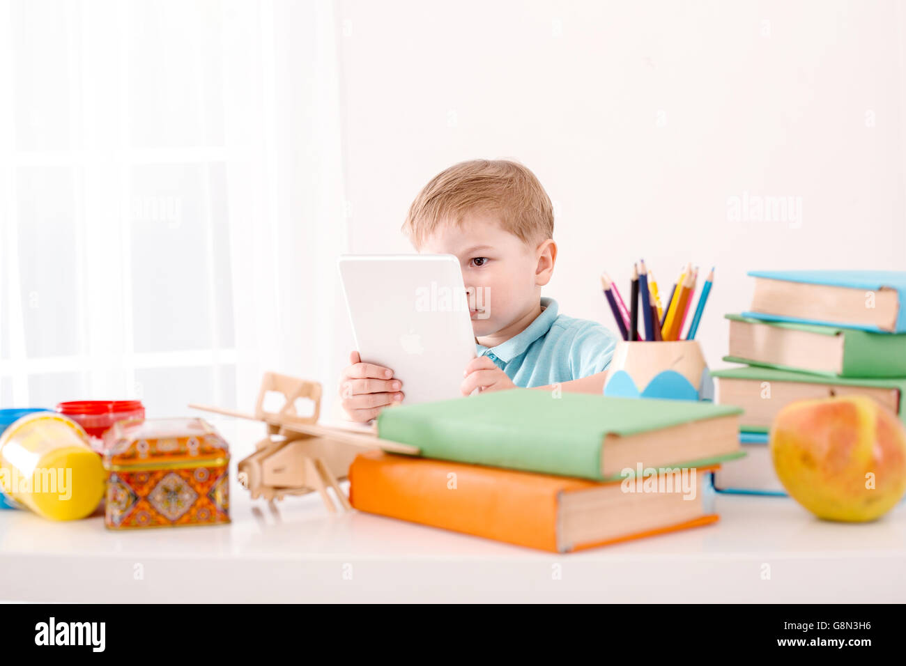 Modern problem: kids and computers. Little boy using tablet computer ...