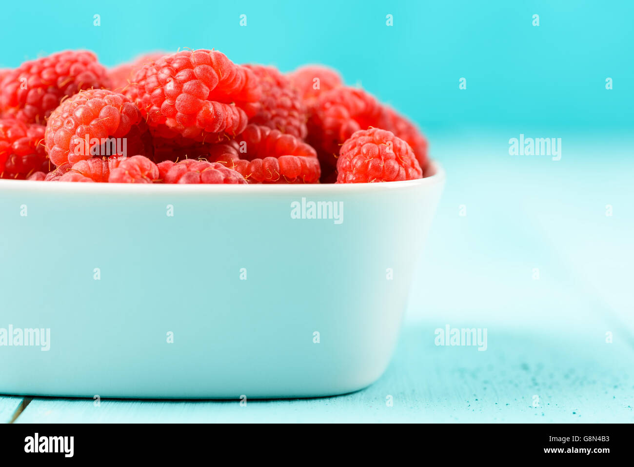 White Bowl Of Red Fresh Raspberries Stock Photo