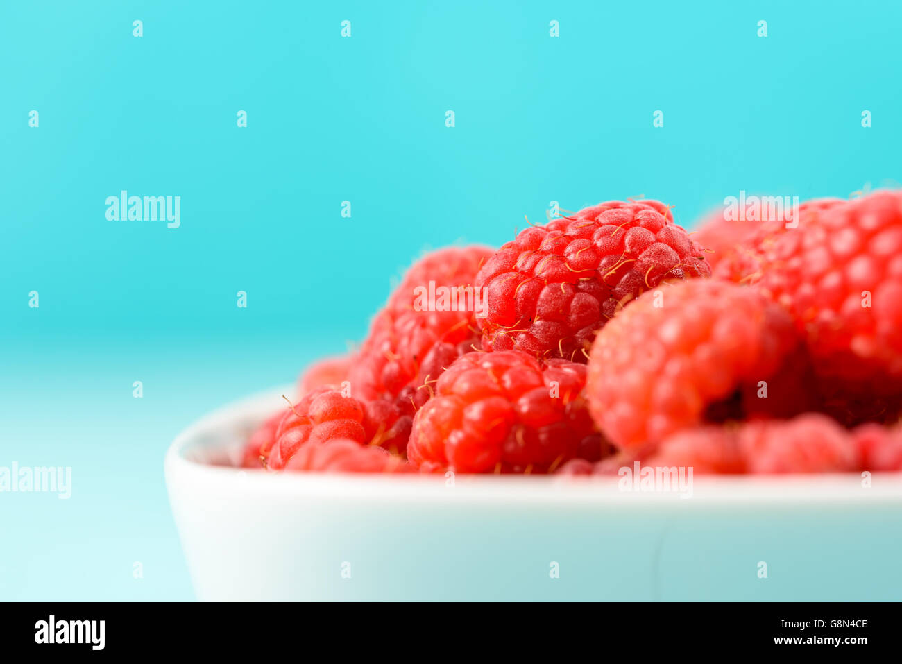 White Bowl Of Red Fresh Raspberries Stock Photo