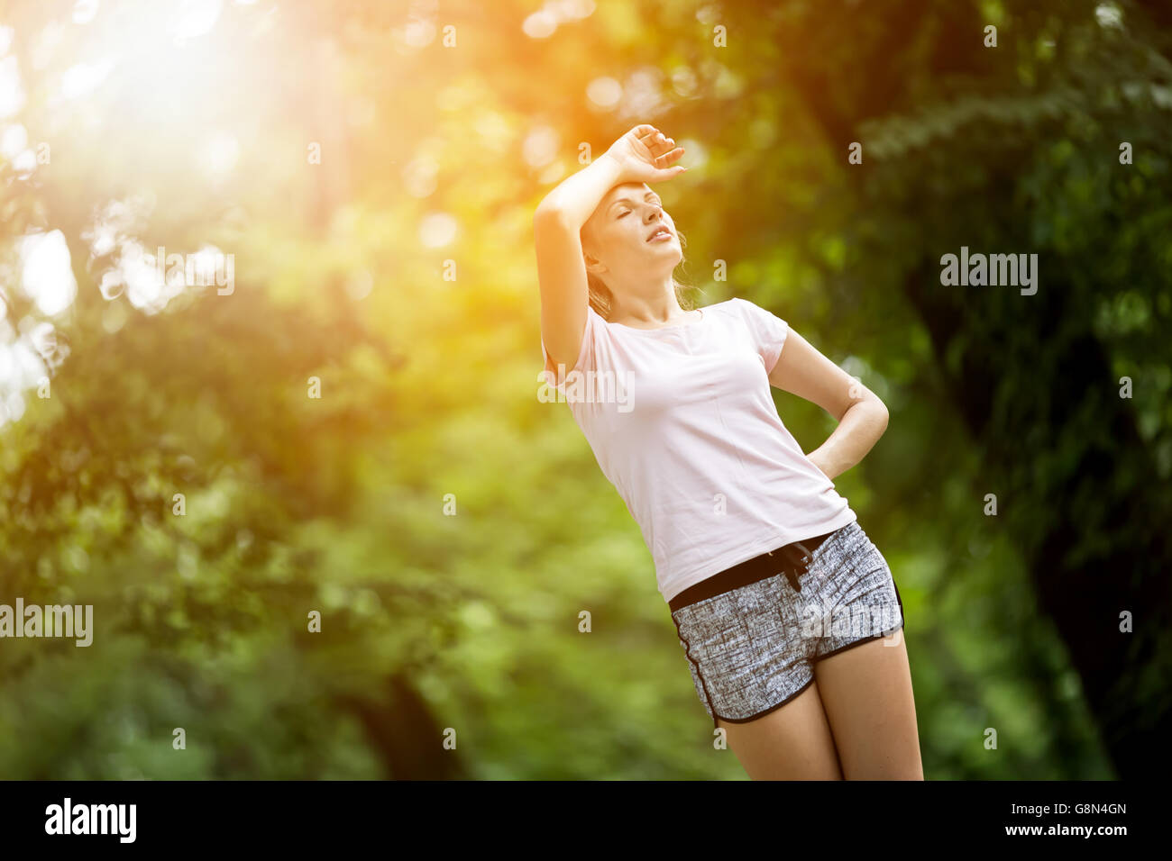 Tired female jogger resting after jogging Stock Photo Alamy