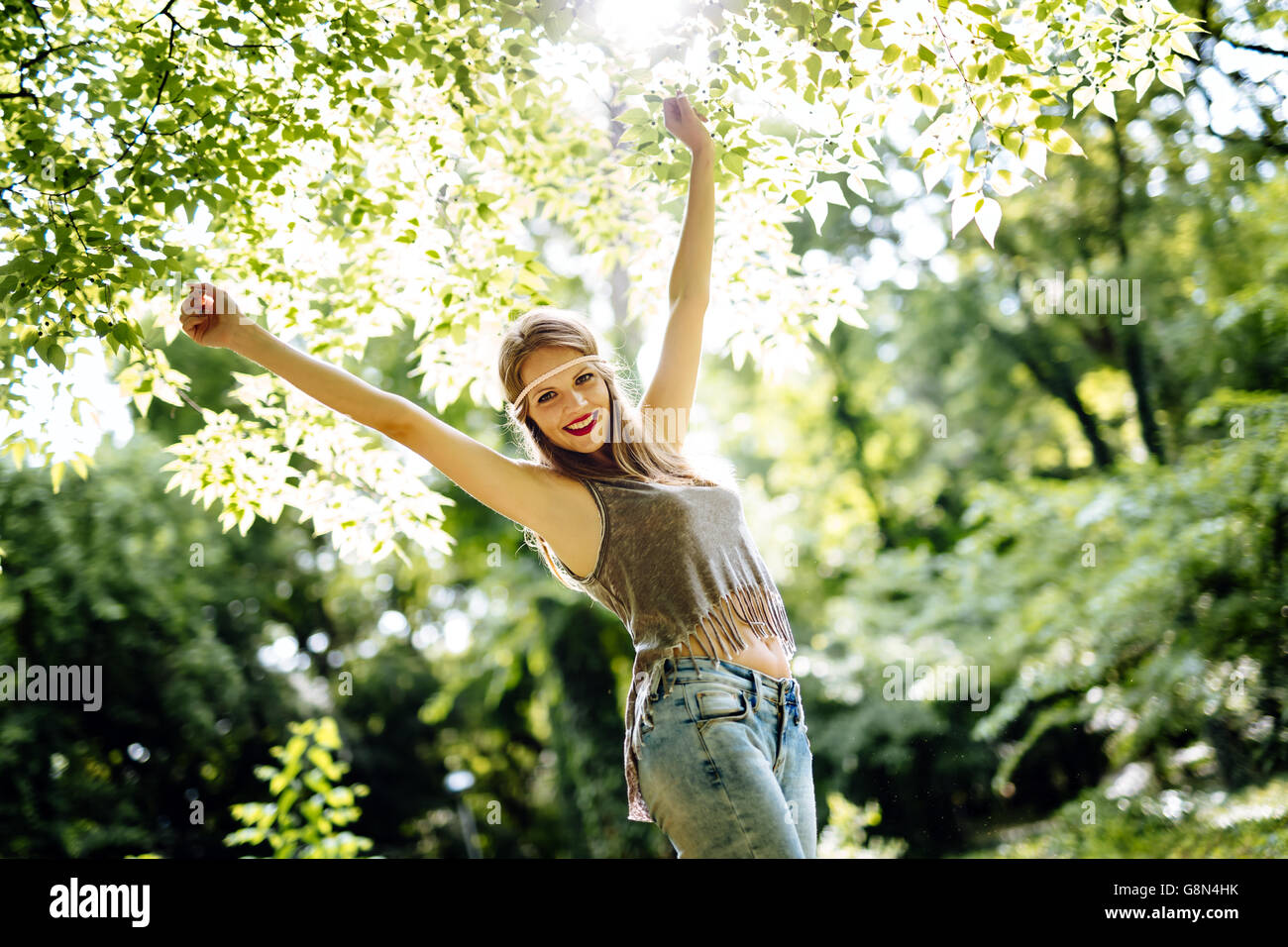 Beautiful smiling blonde hippie in nature Stock Photo