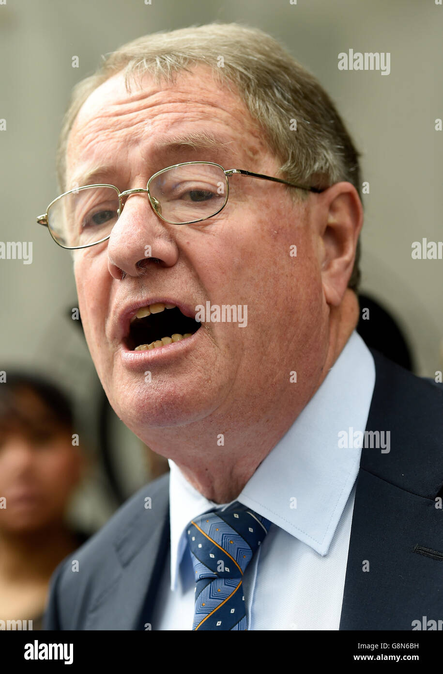 Clifford Chance lawyer Richard Gifford reads a statement outside the