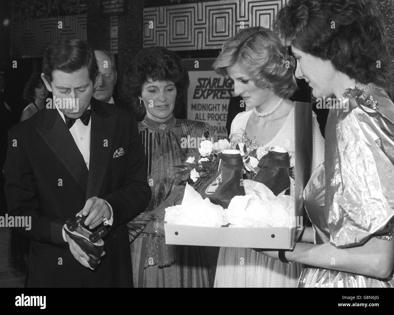 The Prince and Princes of Wales look at a couple of pairs of roller skates destined for their sons during a Gala performance of 'Starlight Express' at the Apollo Victoria Theatre, London. Stock Photo