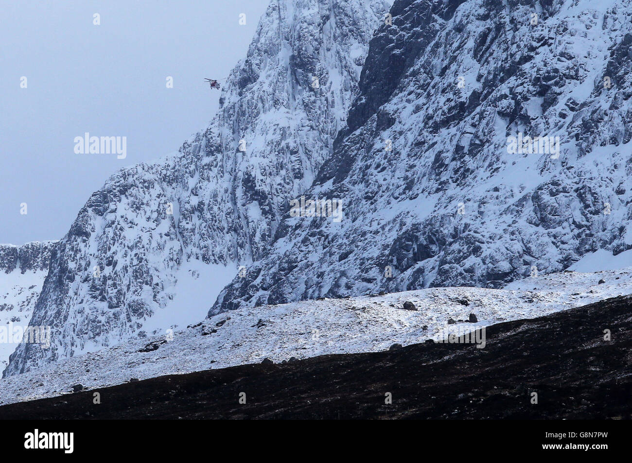 A Coastguard Search and Rescue helicopter searches along the north face of Ben Nevis for missing climbers Rachel Slater, 24, and Tim Newton, 27, as efforts to locate the couple have been been delayed by more bad weather. Stock Photo