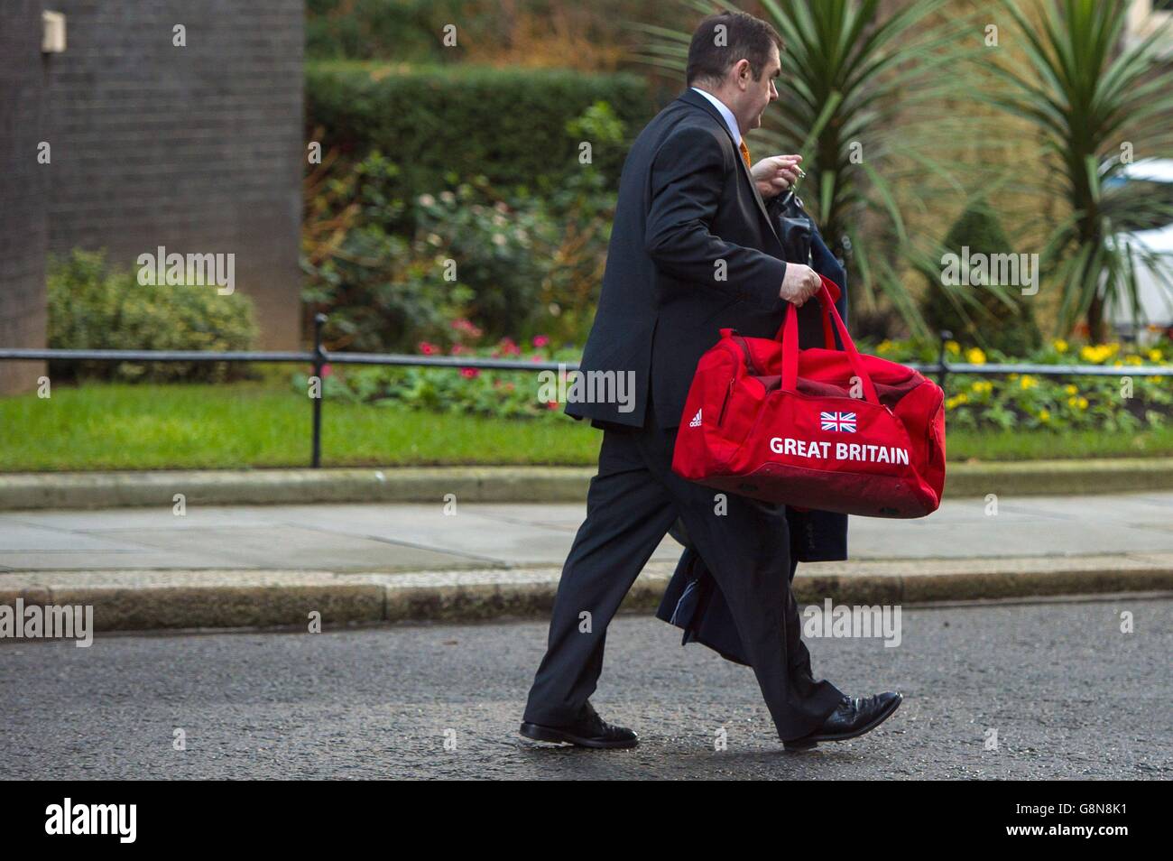 A member of staff carries a bag labelled 'Great Britain' out of 10 Downing Street in Westminster, London, before Prime Minister David Cameron headed to Brussels for a crunch summit of European leaders with key elements of his demands for change in Britain's relations with the EU still in dispute. Stock Photo