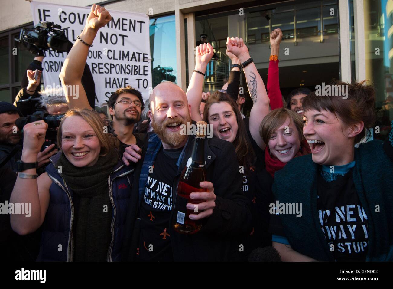 Some of the 13 climate change activists who cancelled 25 flights and triggered vast financial costs and disruption to thousands of passengers at Heathrow Airport celebrate outside Willesden Magistrates Court in London after they each received a suspended six weeks prison term. Stock Photo
