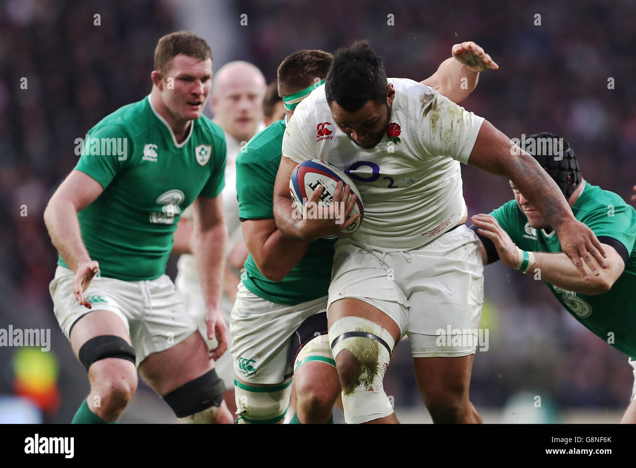 England's Mako Vunipola (centre) is tackled by Ireland's CJ Stander (left) and Mike Ross during the 2016 RBS Six Nations match at Twickenham Stadium, London. Stock Photo