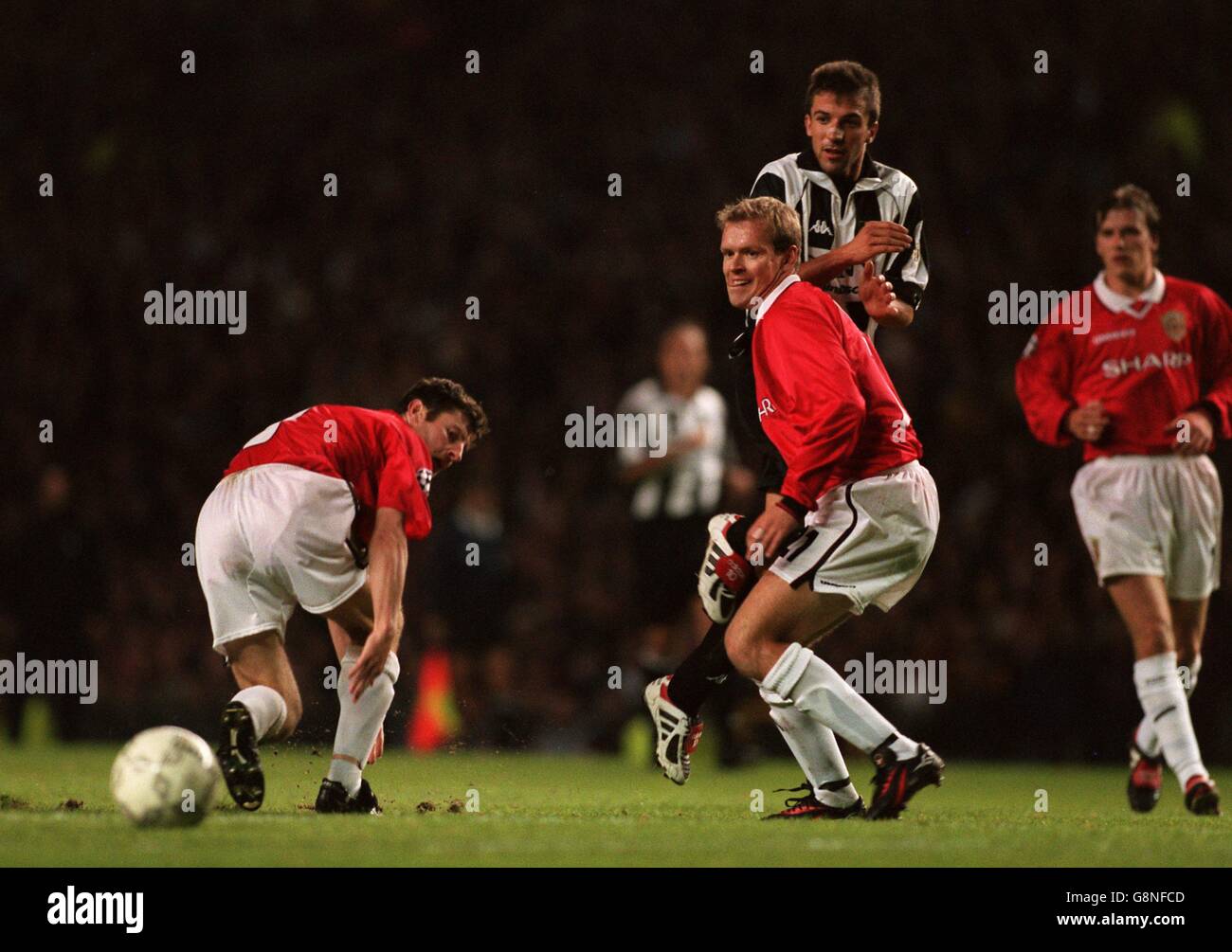 Juventus's Alessandro Del Piero (second right) knocks the ball between Manchester United's Henning Berg (second left) and Denis Irwin (left) as Manchester United's David Beckham (right) watches Stock Photo