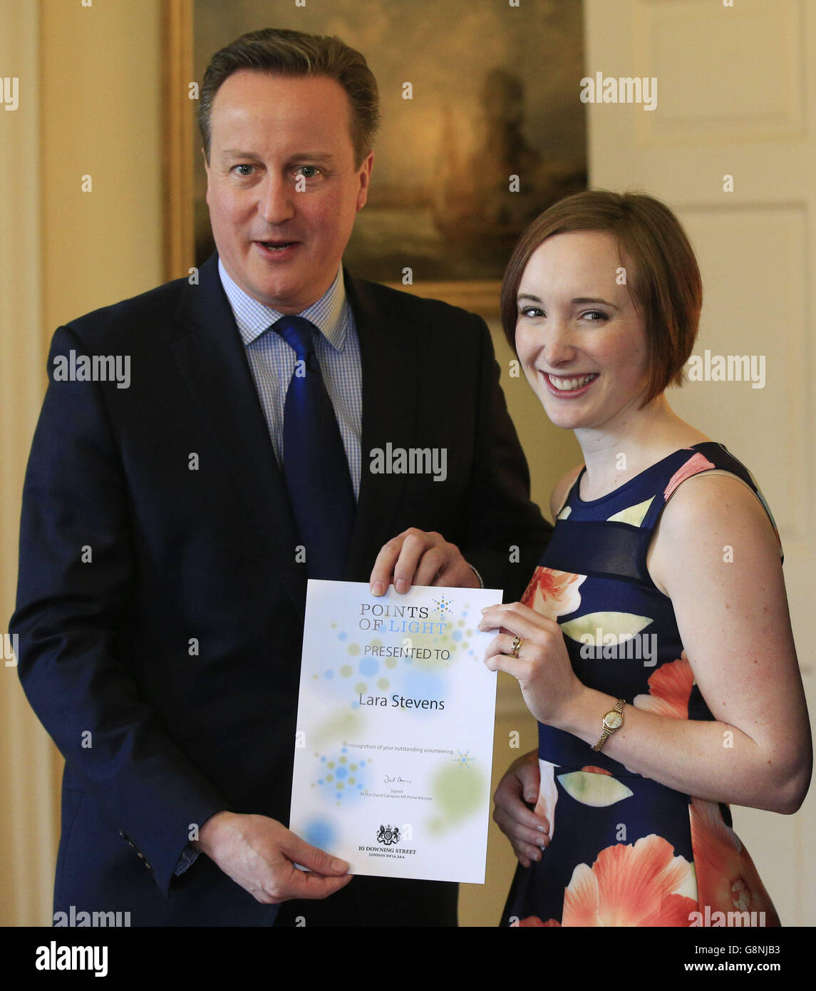 Prime Minister David Cameron presents a Points of Light certificate to
