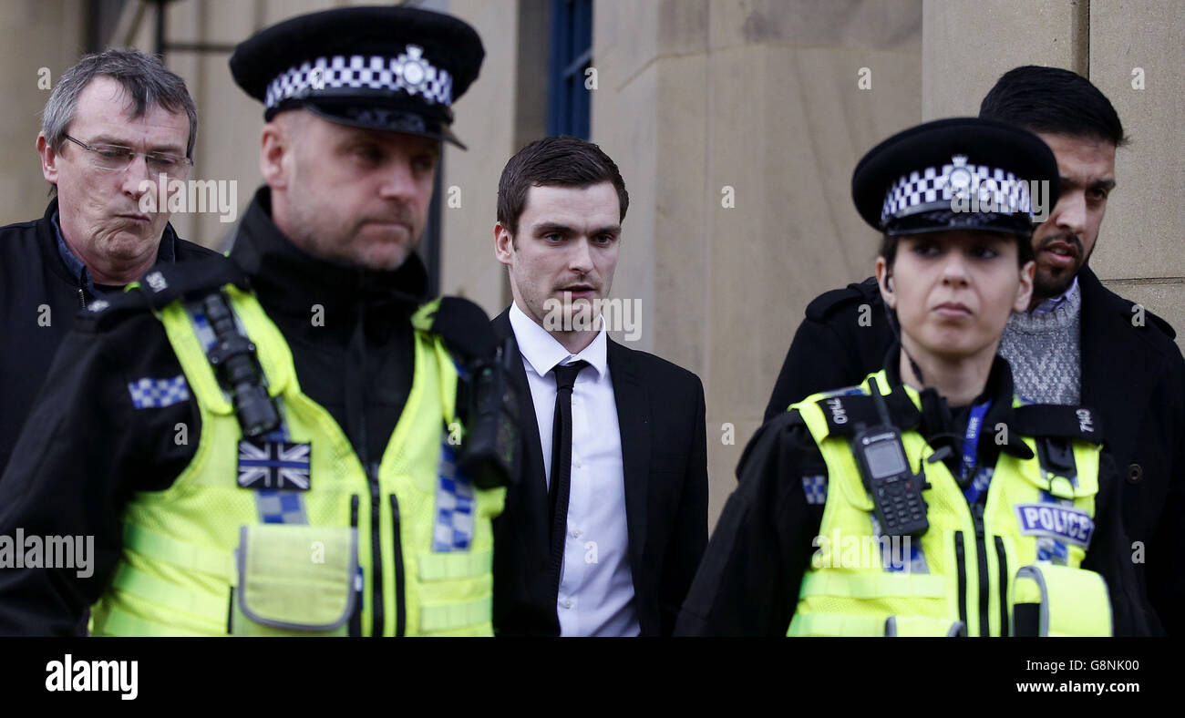 Footballer Adam Johnson (centre) leaves Bradford Crown Court after the jury went sent home for the day in his trial. Stock Photo