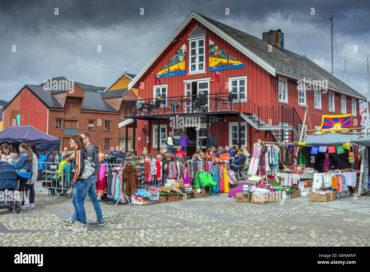 Outdoor festival,with people, stalls and red buildings Kabelvag, Stock Photo