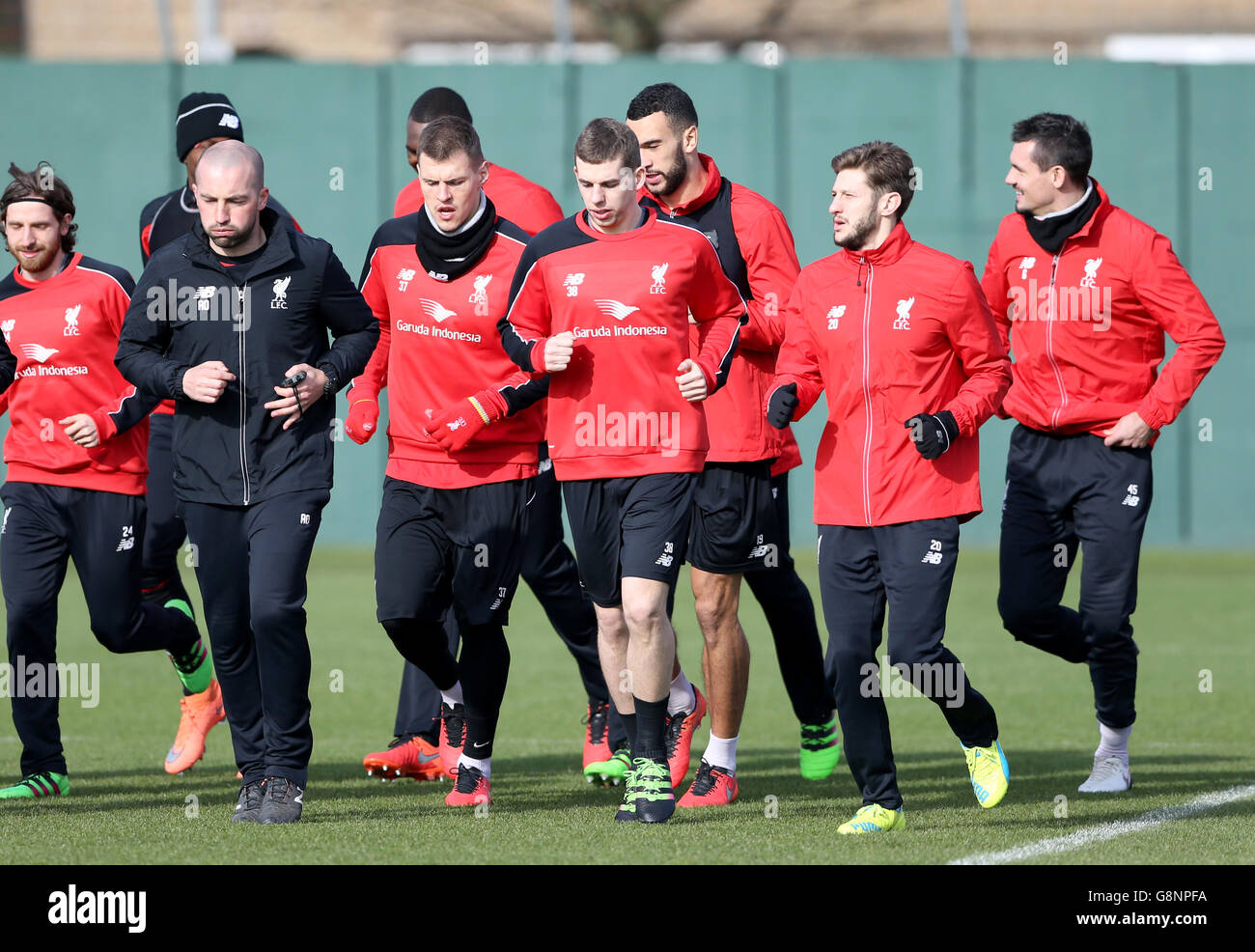Liverpool's Jon Flanagan (centre) warms up alongside teammates Adam Lallana (second right) and Martin Skrtel (fourth left) during a training session ahead of the Capital One Cup Final, at Melwood Training Ground, Liverpool. Stock Photo