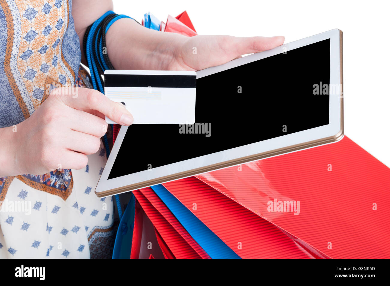 Online payment concept with digital tablet and debit card in close-up in young shopaholic hands isolated on white background Stock Photo