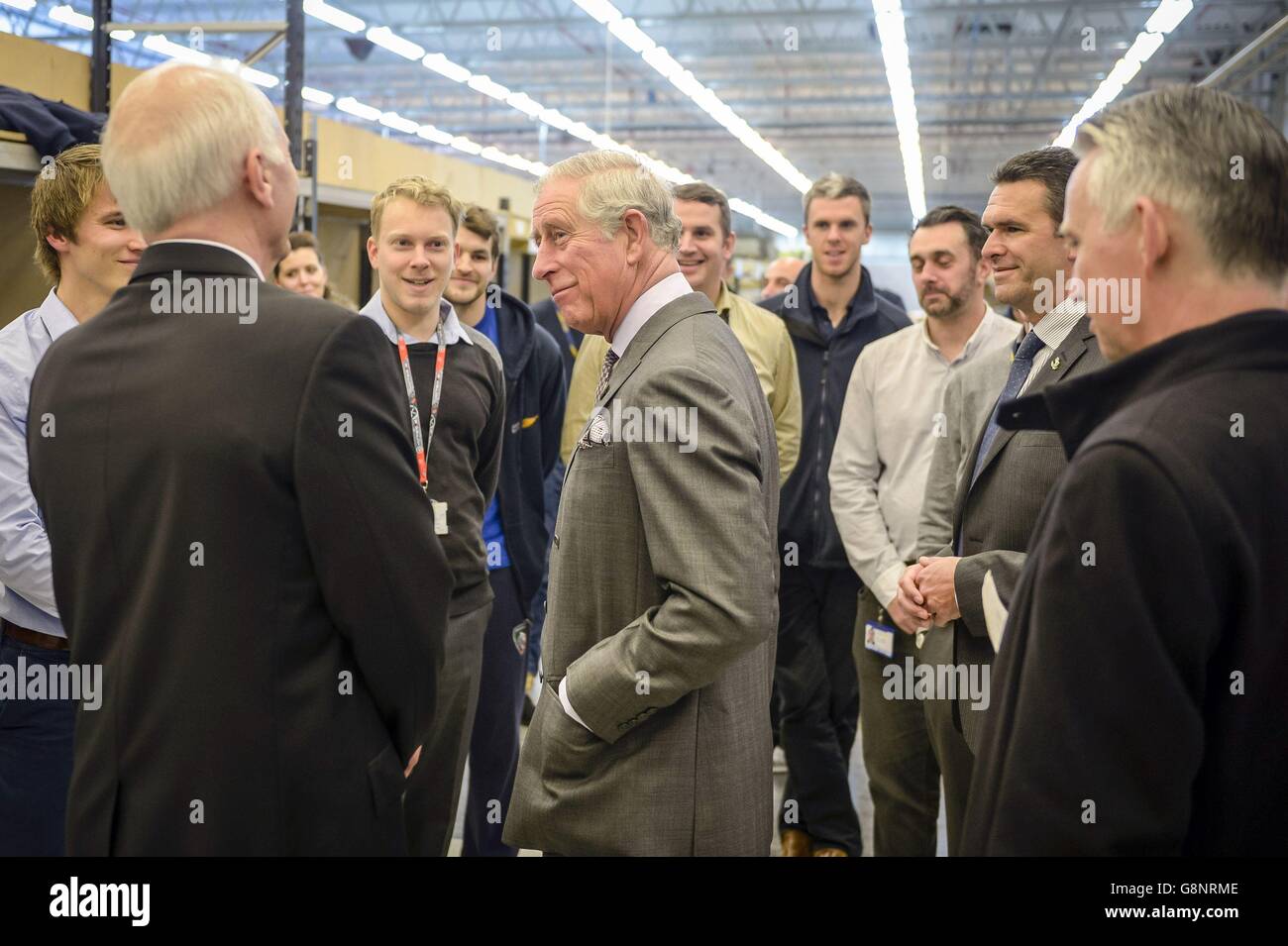 The Prince of Wales chats with staff during a visit to Airborne Systems in Llangeinor, Wales. Stock Photo